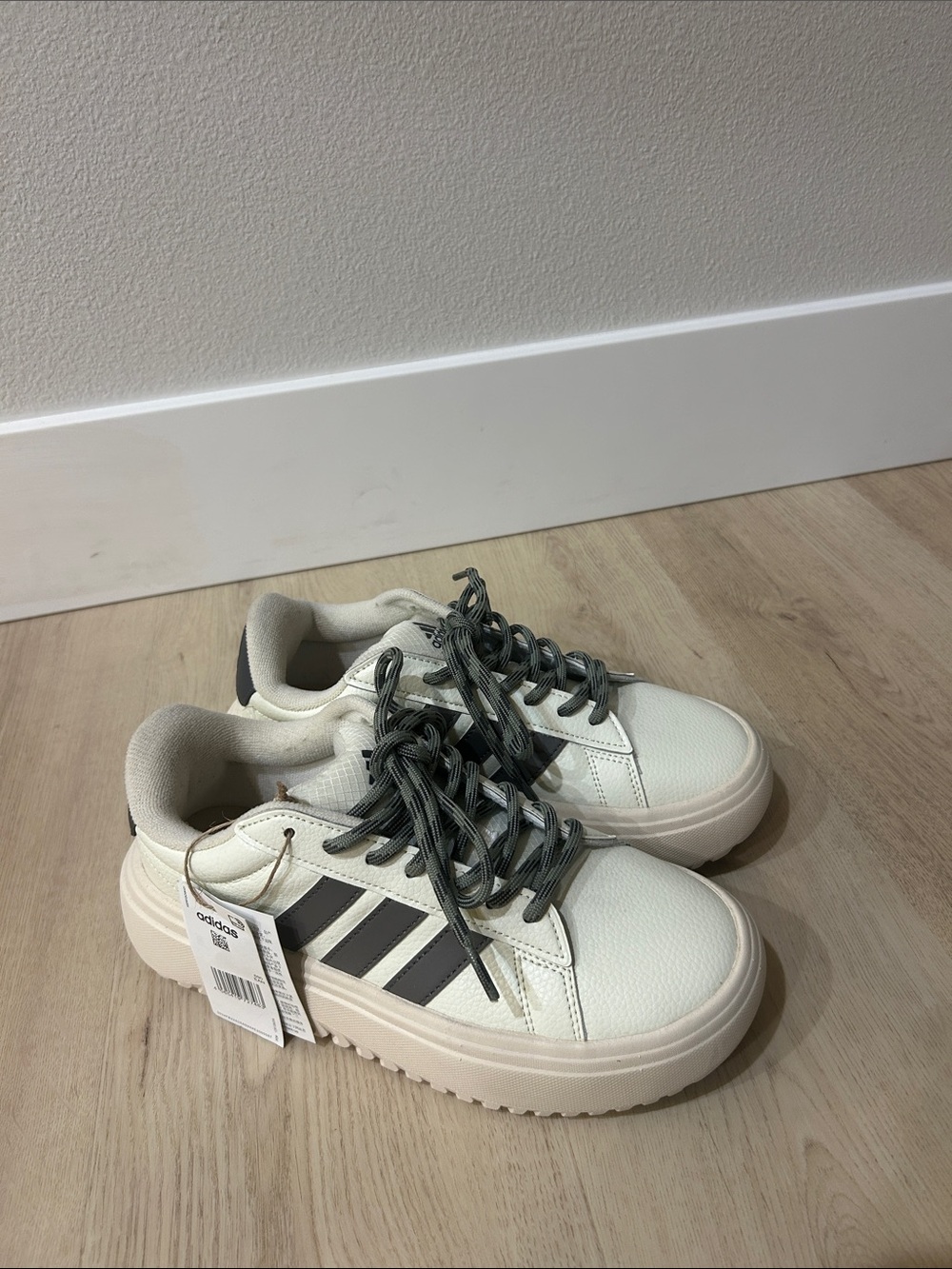 Women’s cream adidas Lace-Up Sneakers with gray stripes sage laces.